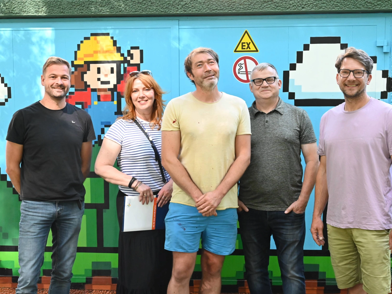 Freuen sich über die gelungene Gestaltung am Alexander-Puschkin-Platz (v.l.): Jan Ortmeier (Stadtwerke Jena Netze), Ulrike Heyde (Stadtwerke Jena), Michael Drosdek (Farbgefühl), Jens Lüthke (Stadtwerke Jena Netze) und Marko Kurth (Heimatkiosk). 