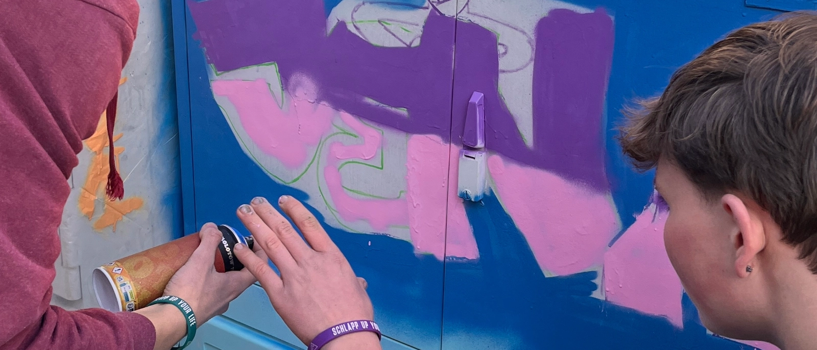 Schüler gestalten einen Stromkasten.